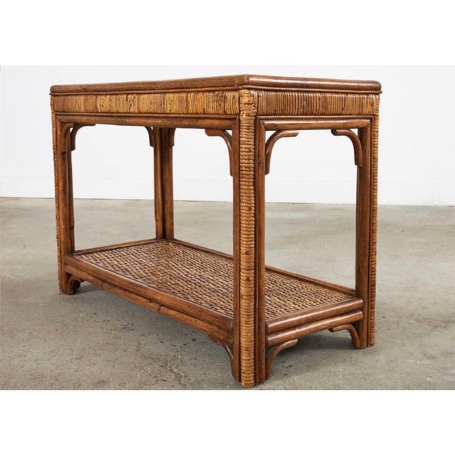 Vintage Rattan and Bamboo console or sofa table with glass top from the 1980s. Nice medium size perfect for an entryway or...