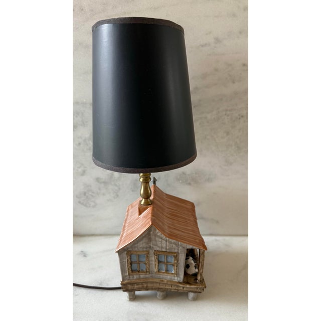 Adorable vintage ceramic pottery table lamp in the shape of a cabin with a dog laying on the front porch, a "Home Sweet...