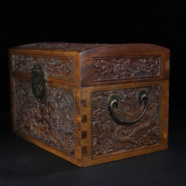 A beautifully crafted Chinese hardwood box, likely rosewood (Huali), featuring intricate relief carvings. The lid and...