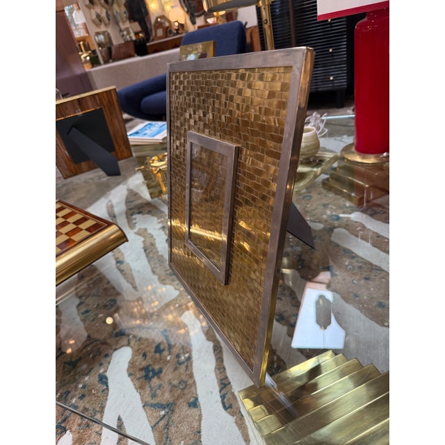 Elegant Italian mid-century picture frame crafted in the 1970s, featuring a beautifully woven brass front that creates a...