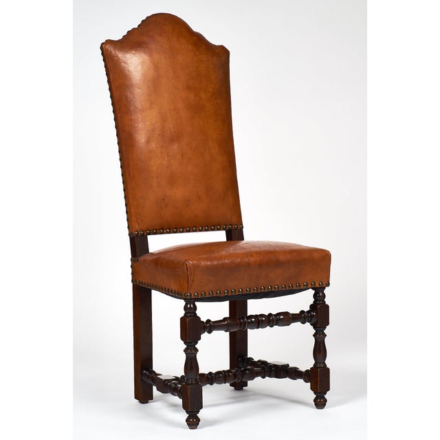 A sumptuous set of six Louis XIII chairs of turned oak with original lambskin upholstery. These chairs have the original...