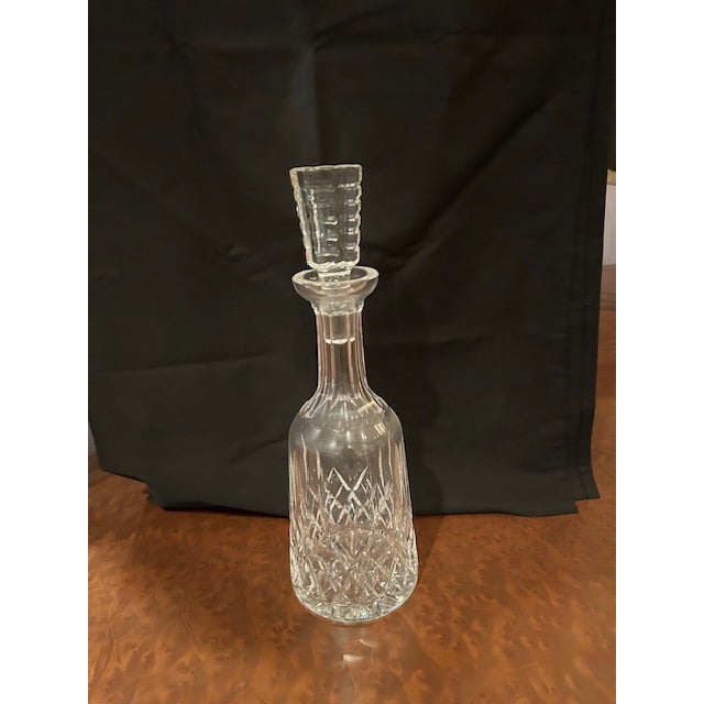 Waterford Crystal Lismore Decatner with a cut design stopper. Excellent condition, never used. Classic Lismore pattern of...