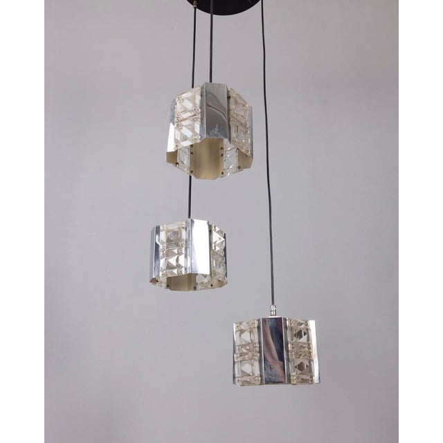 Pendant lamp with three pendants in chromed metal and crystal, designed by Kinkeldey, 1970s. Up to 250V (Europe/UK...
