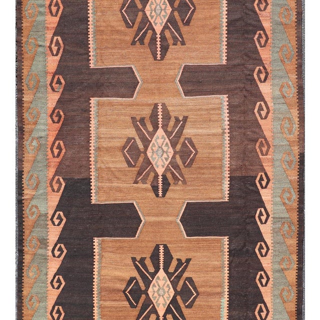 Measures: 5'8 x 10'0 Vintage Turkish Kars Kilim with Bold Medallions in Warm Brown, Orange, and Sage. Keivan Woven Arts /...