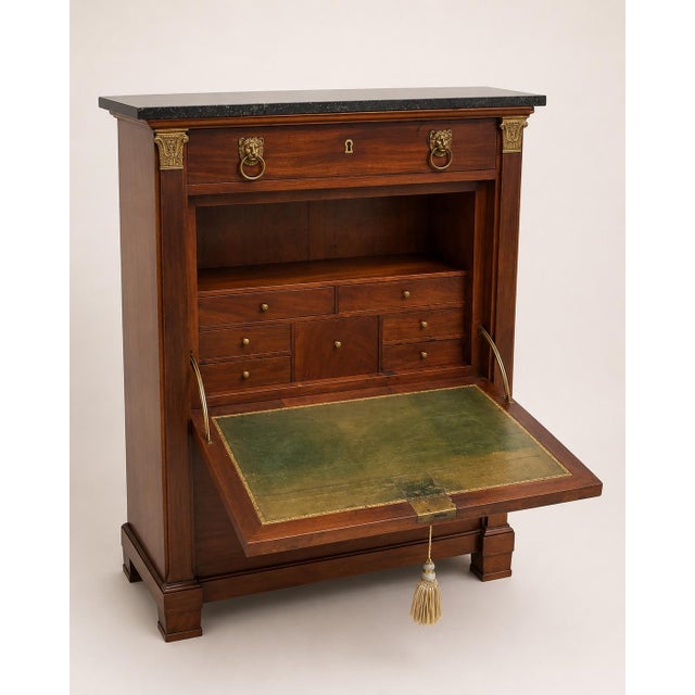 A handsome 19th-century French Empire style secrétaire à abattant crafted in richly figured mahogany and surmounted by its...