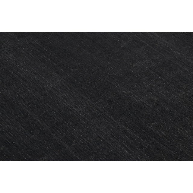 Handwoven in a wool flatweave, this 10x14 contemporary solid Kilim is an exciting addition to both the Kilim & Flat Weave...