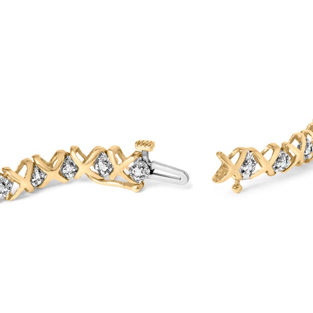 Capturing the essence of both modern style and timeless elegance, this bracelet delicately intertwines 10k yellow gold...