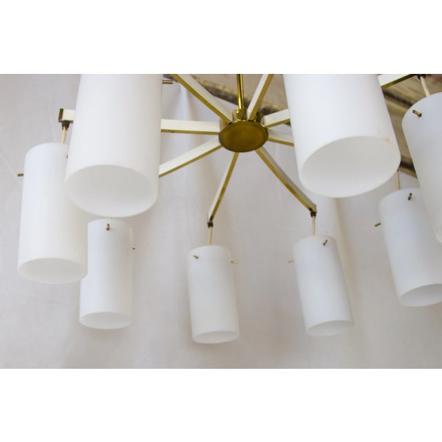 A beautiful chandelier with 8 cylindrical glass shades made in the 1960s by "vereinigte werkstätten münchen". good...
