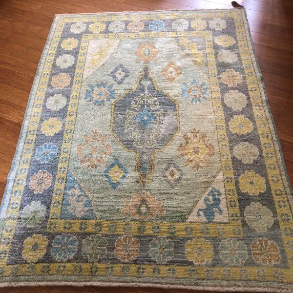 A distinctive contemporary Oushak, this hand-knotted Turkish rug pairs soft light green with deeper charcoal tones,...