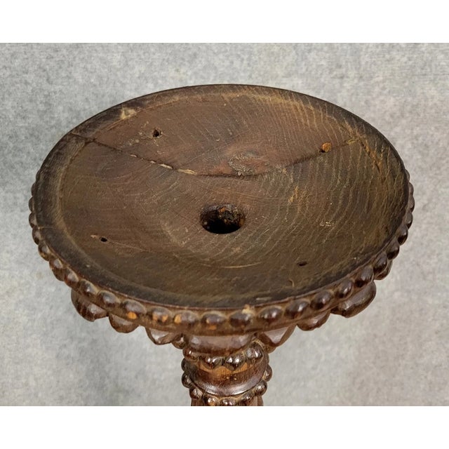 Renaissance style torchiere in carved walnut, 1850 turned and delicately carved body trilobed base with animal-shaped...