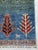 A hand-knotted tribal Gabbeh rug in the Persian Gabbeh tradition, woven in horizontal bands of deep blue and moss green...