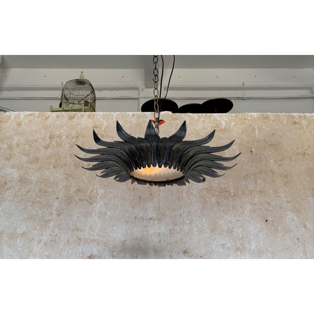 This striking Spanish 1950s metal ceiling fixture features two tiers of overlapping hand-formed leaves arranged in a...