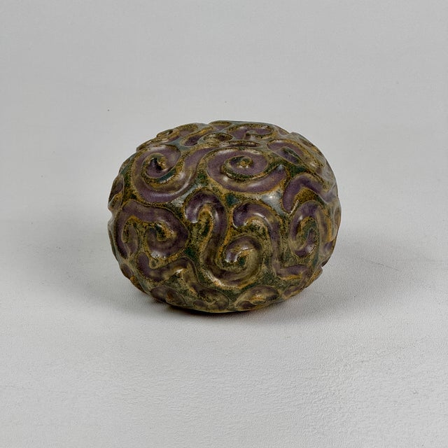 This vintage vase is even nicer in person. Round with swirly design and a gorgeous light purple brings this to...