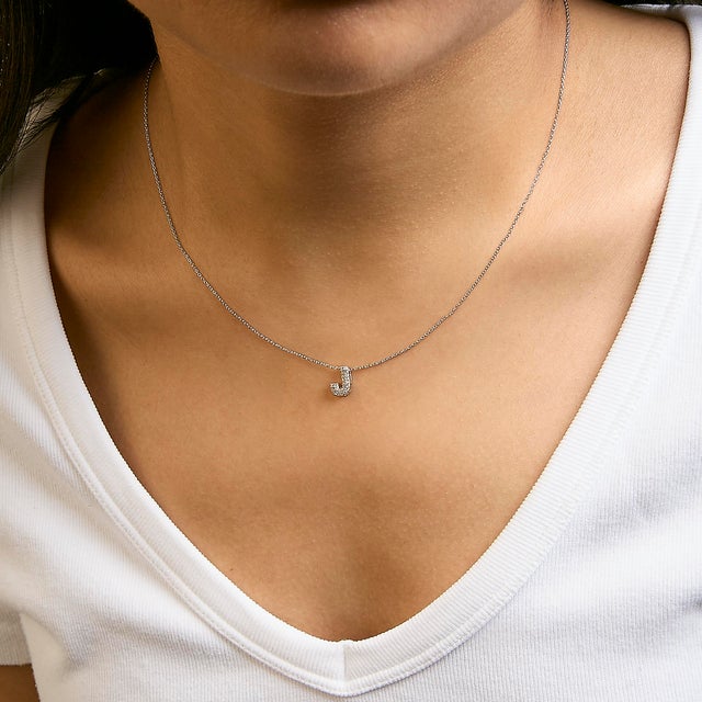 Elegance meets personalized charm in this exquisite pendant, meticulously crafted from radiant 10K white gold with a...