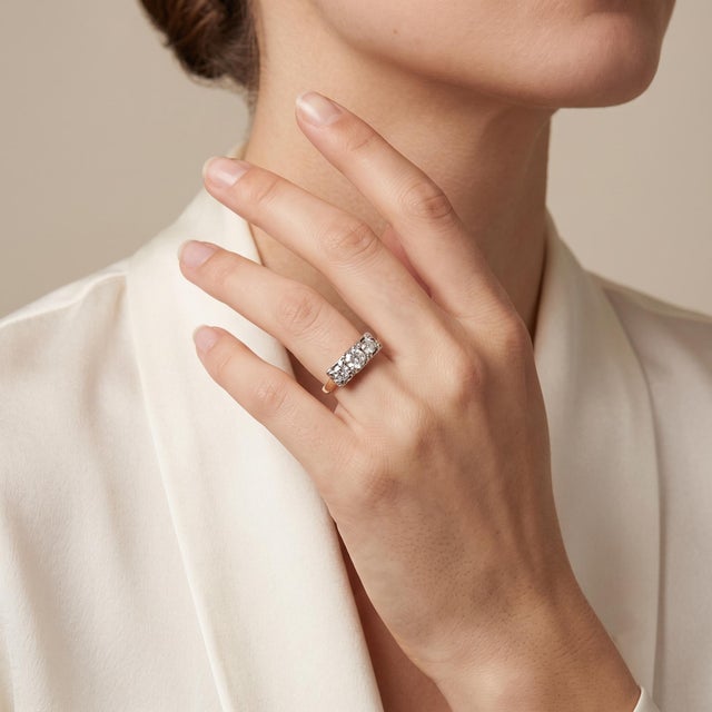 Discover the timeless elegance of our Antique Trinity Stone Engagement Ring, crafted in luxurious 14k two-tone yellow and...