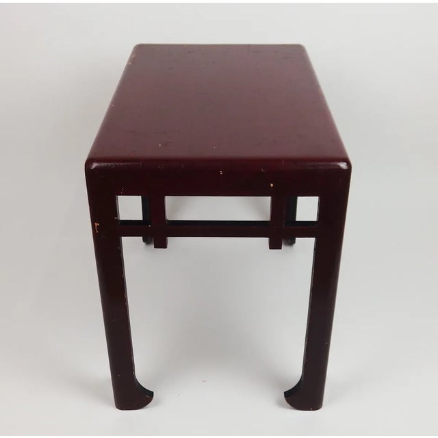 Rectangular side table with a rounded top on the corners, a gallery under the top, made up of a horizontal bar and two...