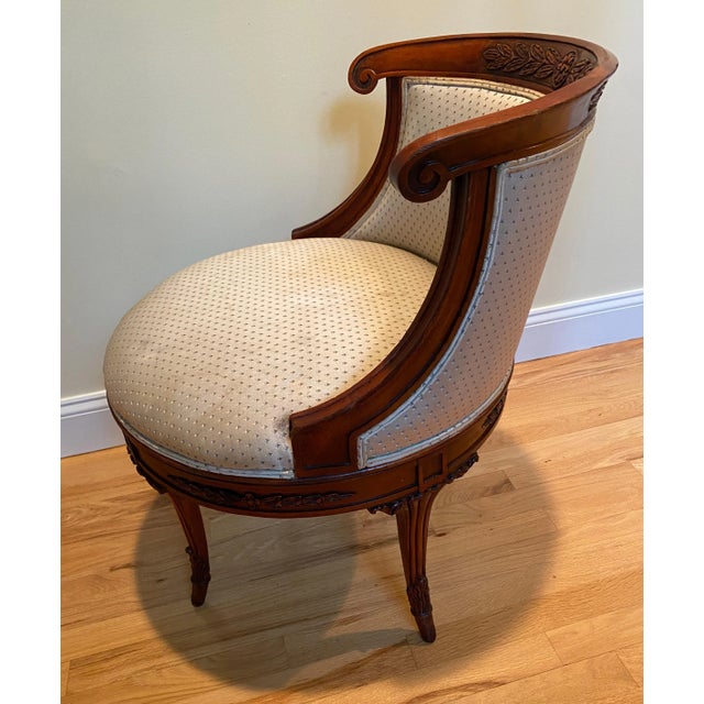 This is a very unusual wooden upholstered chair that spins 360 degrees like a barrel chair. The wood is in good shape but...