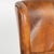 Pair of 20th century Danish wingback club chairs upholstered in vintage brown leather. Classic wingback forms, rolled...