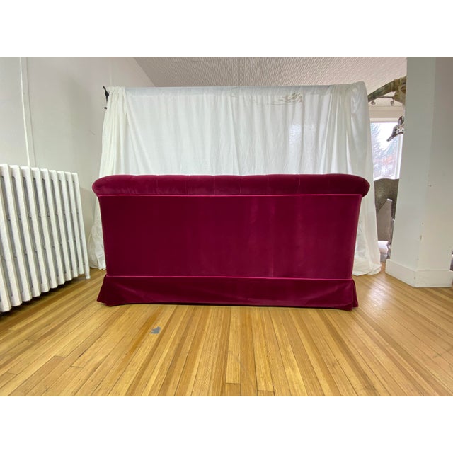 Custom tufted loveseat newly reupholstered in cranberry mohair with hot pink welting. Traditional style piece from the 1990s.