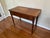 19th Century wood writing table with single drawer and turned legs. The desktop has developed a beautiful patina as it's...