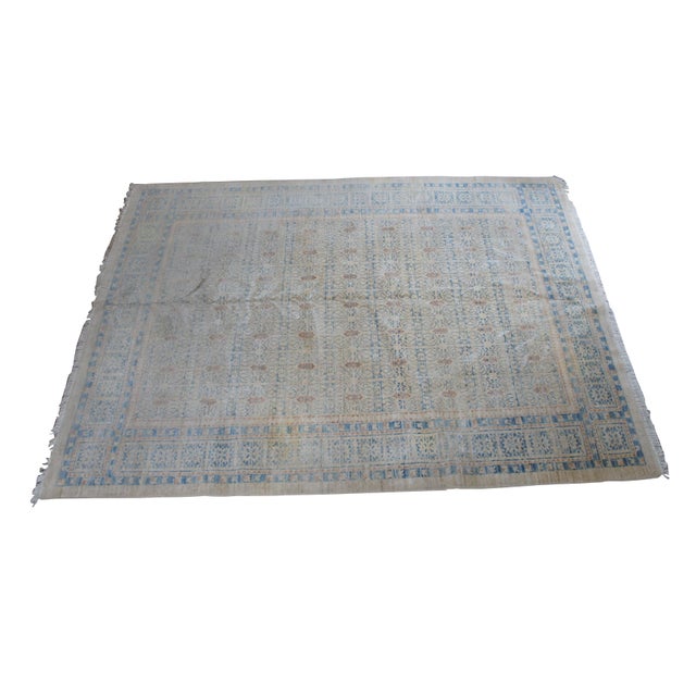 Hand knotted oriental geometric wool area rug. Features a beige foreground with blue and reddish orange details....