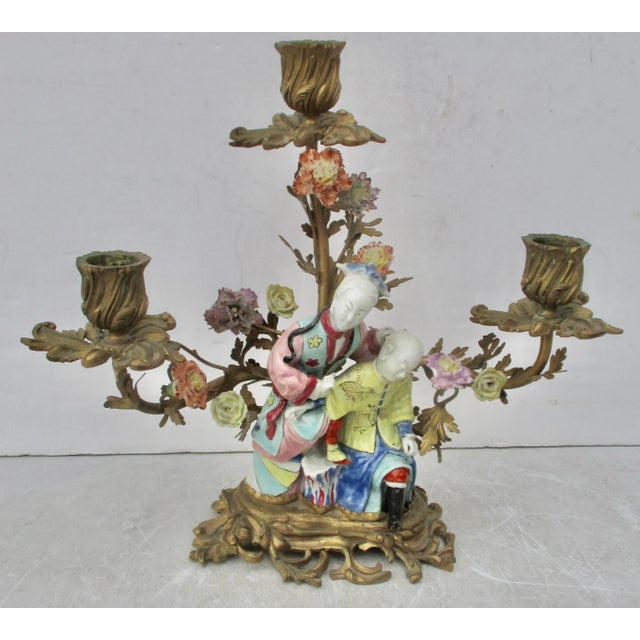 18th-century Chinese porcelain couple seated on rockwork and mounted in a gilt bronze European Baroque base with porcelain...