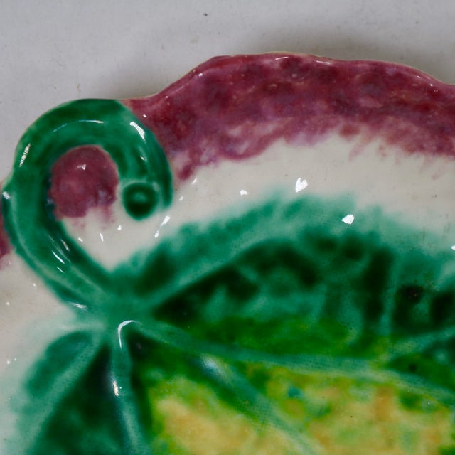 Bring a vibrant splash of botanical charm to your tabletop or gallery wall with this vintage mid-century modern Majolica...