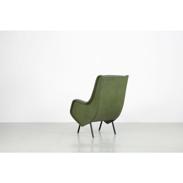 This armchair in the style of Aldo Morbelli was made in Italy in the 1950s. The armchair with armrests features a green...