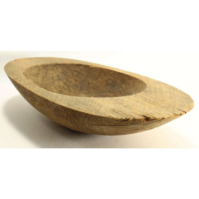 A very interesting and unusual early treenware bowl Hand carved oval shaped small trencher with wide border Lathe turned...