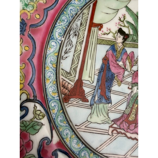 Exquisite early 20th century Chinese export-style Famille Rose porcelain decorative plate. Featuring a meticulously hand-...