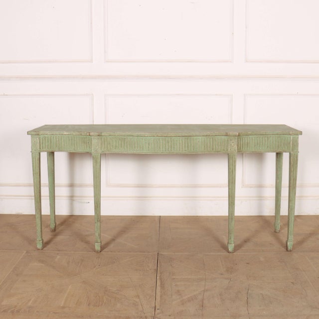 Late 18th century English painted oak console table with fluting to the legs and frieze. 1790. This piece is designed in...