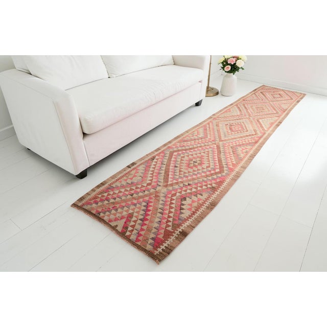 This is a vintage Turkish Oushak rug from the Mid 20th Century. The piece was hand-knotted.