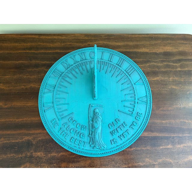 A classic vintage iron verdigris garden sundial inspired by traditional English estate landscapes, reading "Grow old along...