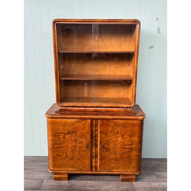 1930s/1940s Display Cabinet Crafted in the Art Deco style from walnut burl. Solid and well-proportioned structure, with...