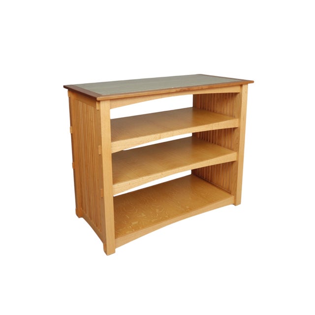 A custom-made craftsman style bookcase in oak, with a green marble top. Four shelves are decorated with arched edges, and...