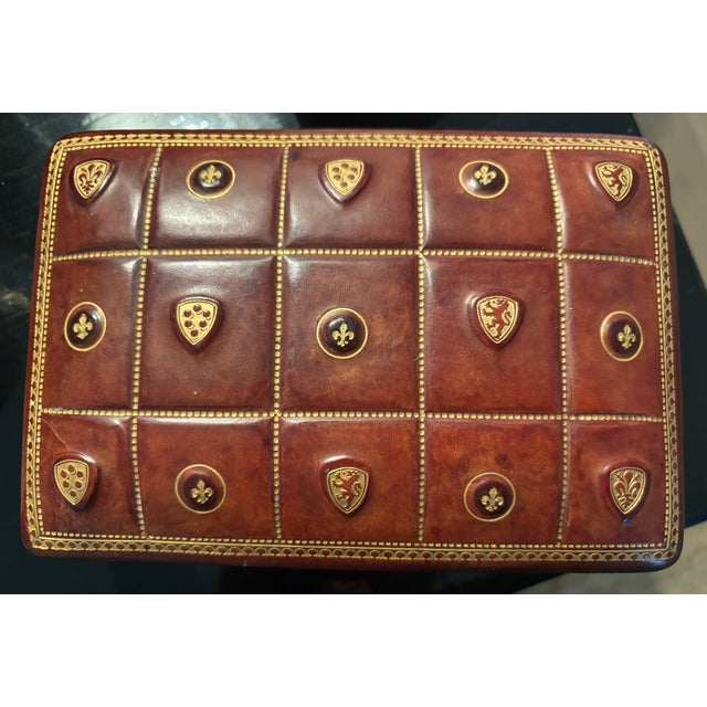 A refined and collectible Mid-Century Italian leather playing card box clad in warm, hand-tooled leather, decorated with a...