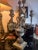 A striking vintage-style candelabra with a dramatic baroque silhouette, sculptural scroll arms, aged metallic finish, and...
