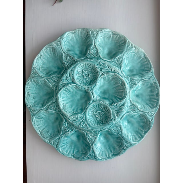 Mid-20th century oyster platter from Gien, Loire Valley, France. Turquoise glaze, scalloped edge, twelve shell-form wells...