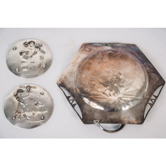 This beautiful set of decorative silver dishes are decorated with charming designs showing children walking dogs. The...