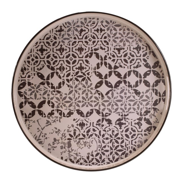 Elevate your home decor with the Round Ornate Geometric Print Tray. Featuring bright white and beige tones with bold black...