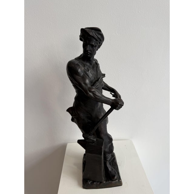 Bronze sculpture of a blacksmith from the 19th century. France. This sculpture depicts a blacksmith resting, wearing the...