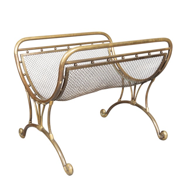 An unusual form with wire mesh basket and tubular brass frame. Scrolled legs.