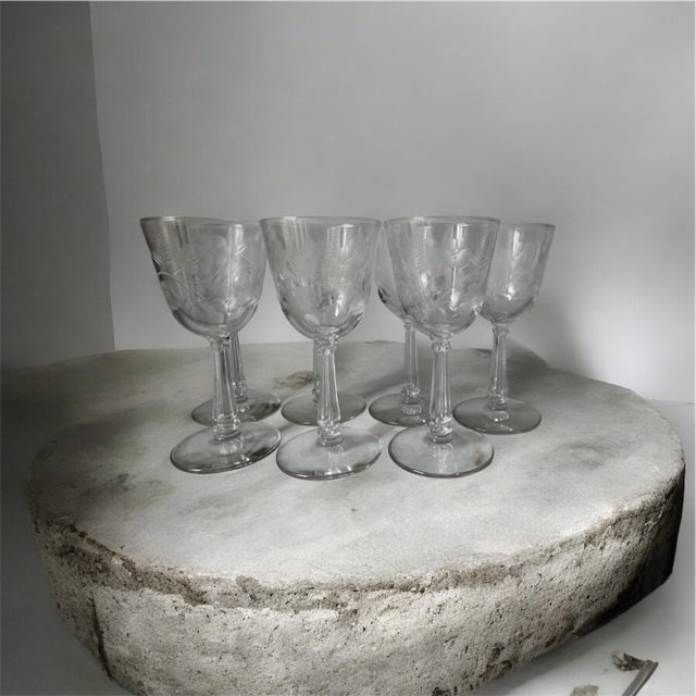 This product is a set of 7 vintage wine glasses by Libbey Glass Company, featuring an elegant Crystal Garland pattern with...