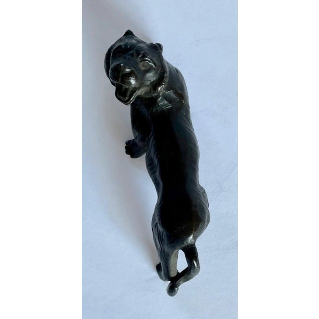 In a classical style, this could be a tiger or female lion sculpture or paperweight. Not sure of the type of metal,...