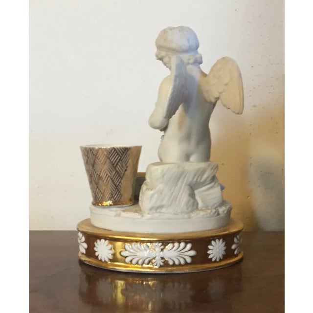 Antique early 19th c. old Paris porcelain inkwell in the form of a winged putti holding a garland of flowers with gilt...