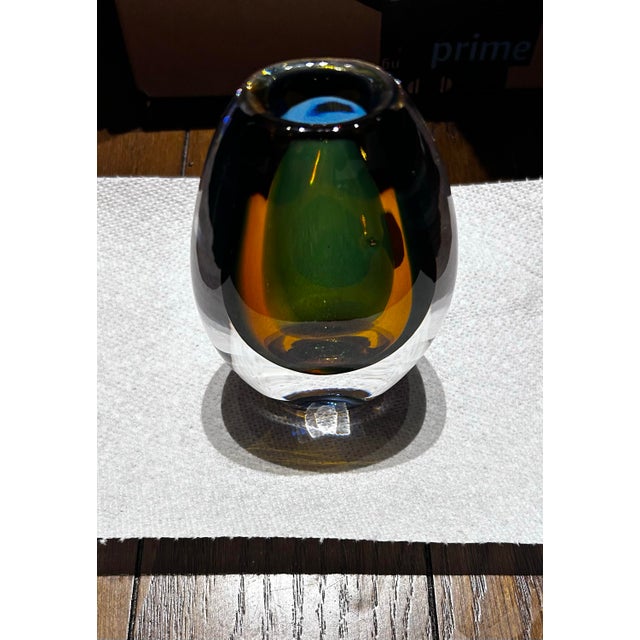 Rare, wondrous art piece designed by Vicke Lindstrand for Kosta Boda (Sweden, 1950-60s). This is a multicolor vase. Amber,...