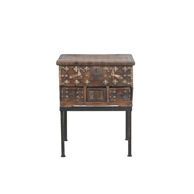 This Vintage Indian Teak and Brass Small Chest on Iron Legs/Side Table is crafted from solid teakwood, adorned with brass...