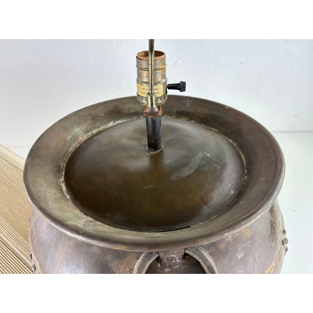 This is a mid 20th century hand hammered rustic large metal table lamp. This table lamp features two hand forged handles...