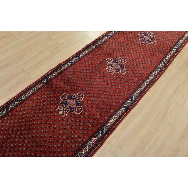 An authentic vintage tribal Mir runner hand-knotted with fine wool and natural dyes. This oriental rug features a central...