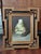 A striking set of three decorative still life paintings depicting ornate porcelain vessels in richly detailed chinoiserie...